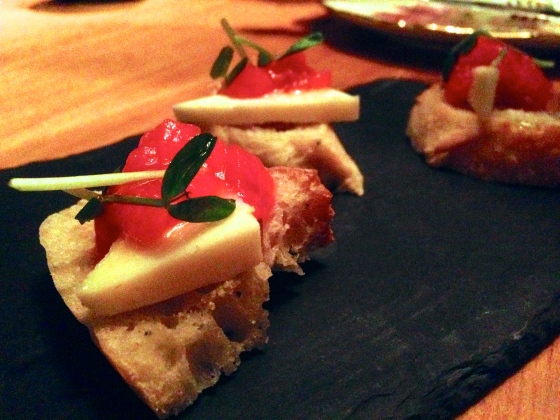 ciabatta toast with sheepmilk's cheese aged with walnut leaf topped with rhubarb jam and pea shoots